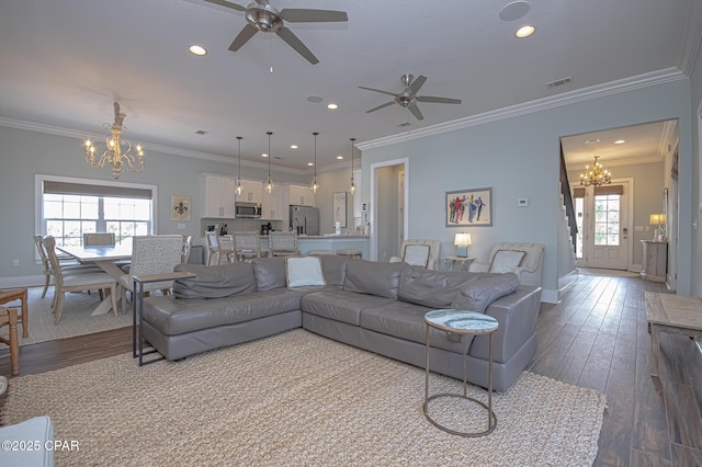 living room with ornamental molding, a healthy amount of sunlight, and wood-type flooring