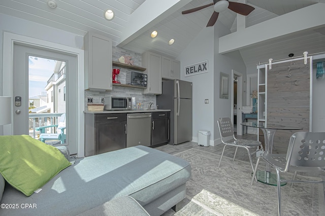 kitchen featuring white cabinetry, vaulted ceiling with beams, backsplash, ceiling fan, and stainless steel appliances