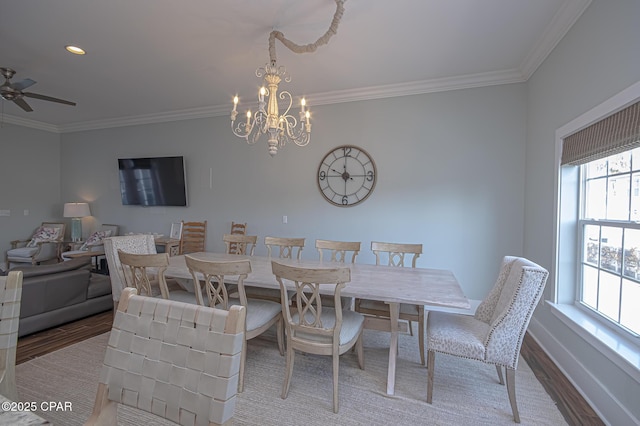 dining area with crown molding, hardwood / wood-style flooring, and ceiling fan with notable chandelier