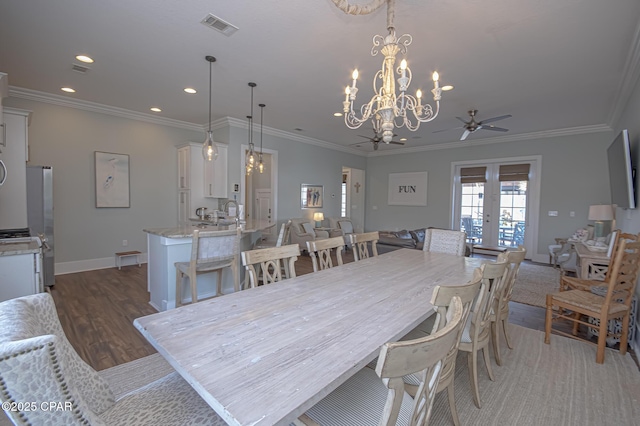 dining room featuring dark wood-type flooring, ornamental molding, french doors, and ceiling fan