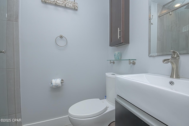 bathroom featuring walk in shower, vanity, and toilet