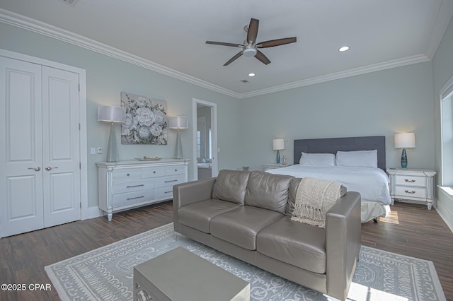 bedroom featuring ornamental molding, dark wood-type flooring, ceiling fan, and a closet