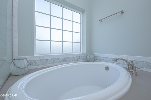 bathroom with a washtub and plenty of natural light