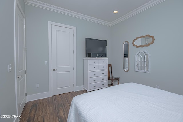 bedroom featuring ornamental molding and dark hardwood / wood-style flooring