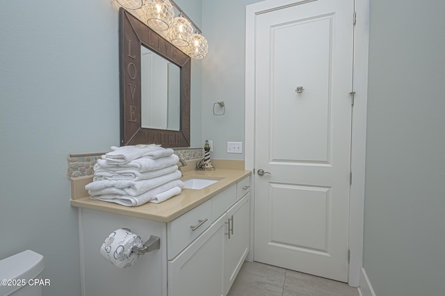 bathroom featuring vanity, toilet, and tile patterned flooring