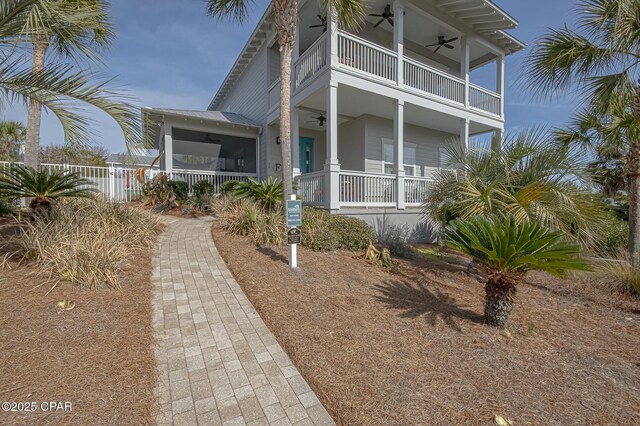 view of front of house featuring a balcony, ceiling fan, and a porch