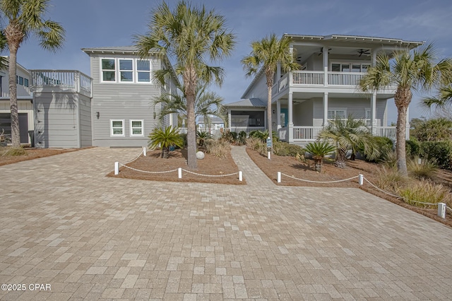 view of front of property featuring a balcony and ceiling fan