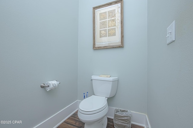 bathroom featuring wood-type flooring and toilet