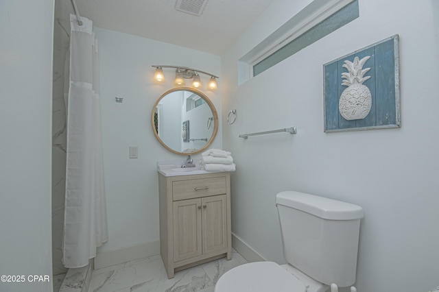 bathroom with vanity, curtained shower, and toilet