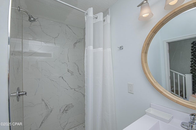 bathroom featuring a shower with curtain, sink, and a textured ceiling