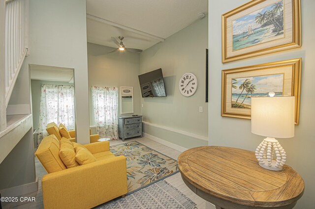 living room featuring tile patterned floors and ceiling fan