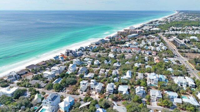 bird's eye view with a water view and a beach view