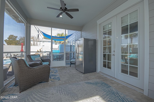 sunroom with a wealth of natural light, french doors, and ceiling fan