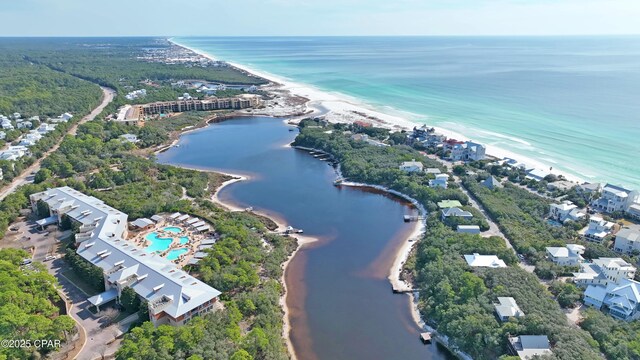 birds eye view of property with a water view and a beach view