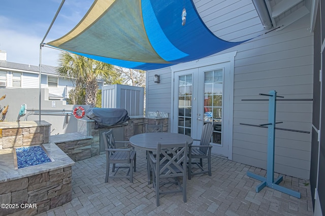 view of patio featuring french doors and an outdoor fire pit