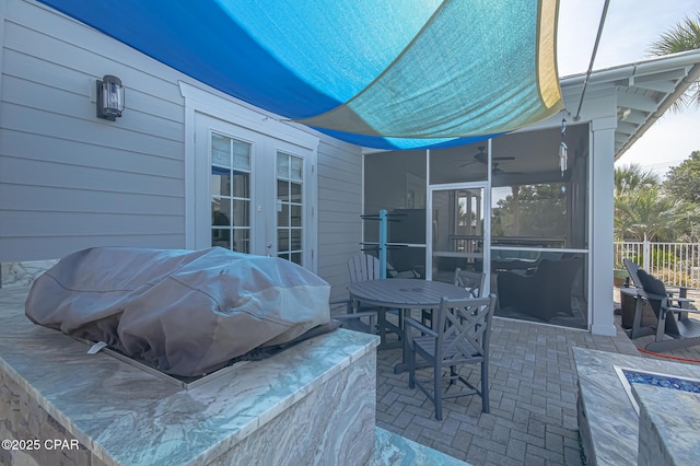 view of patio / terrace with grilling area, ceiling fan, and french doors