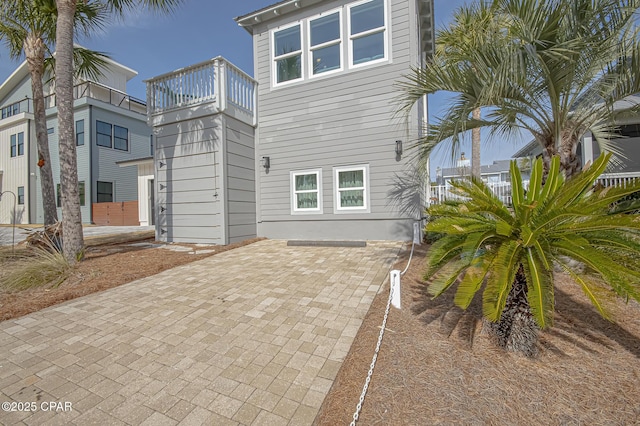 rear view of property featuring a balcony