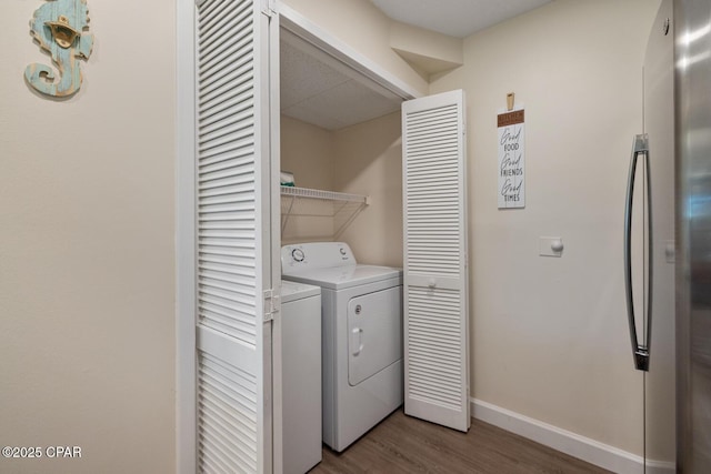 laundry room featuring washing machine and dryer and light hardwood / wood-style floors