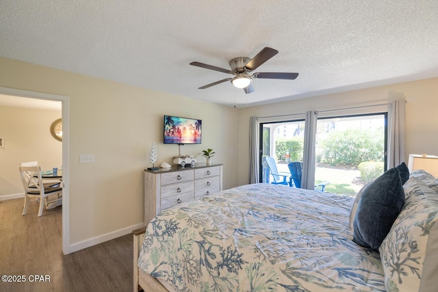 bedroom featuring hardwood / wood-style flooring, ceiling fan, a textured ceiling, and access to outside