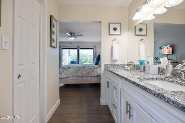 bathroom with ceiling fan, vanity, and hardwood / wood-style floors