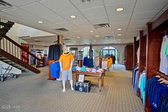 playroom featuring a paneled ceiling and carpet flooring