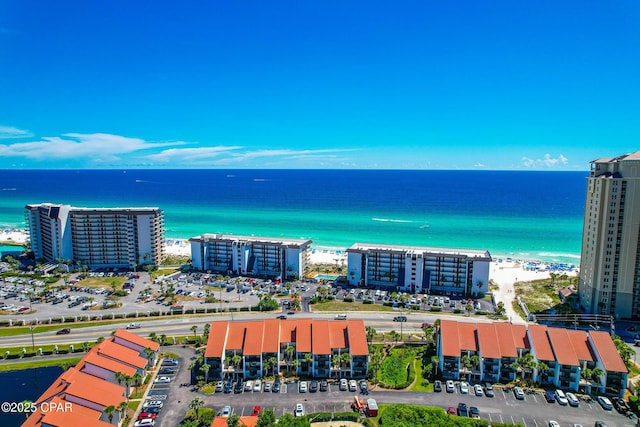 bird's eye view with a water view and a beach view