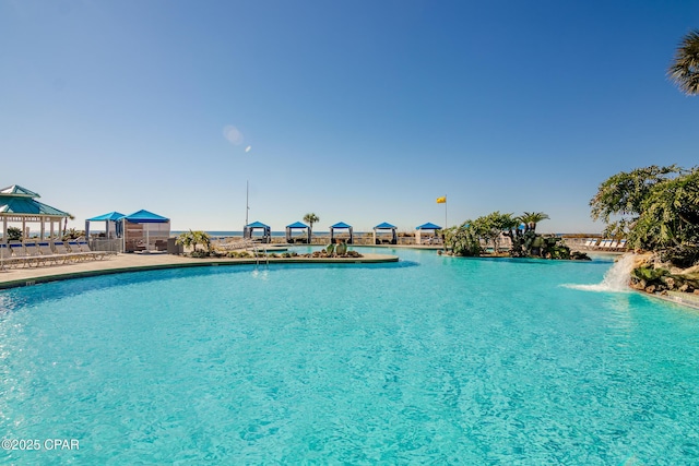 view of swimming pool with a gazebo and pool water feature