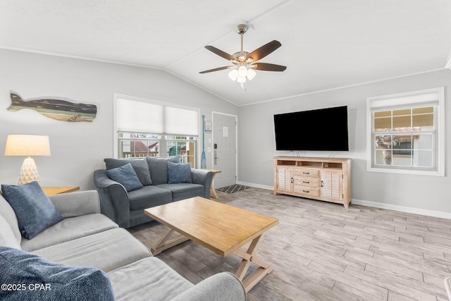 living room with lofted ceiling, light wood-type flooring, baseboards, and a ceiling fan