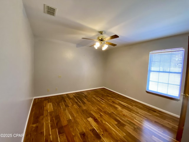 spare room featuring ceiling fan and dark hardwood / wood-style flooring