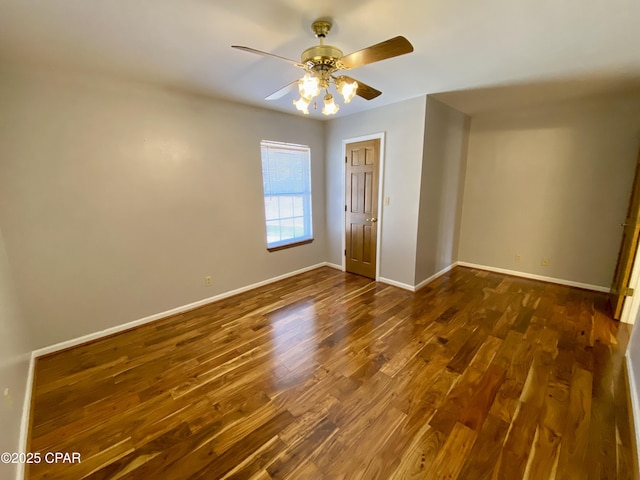 unfurnished bedroom featuring ceiling fan and dark hardwood / wood-style floors