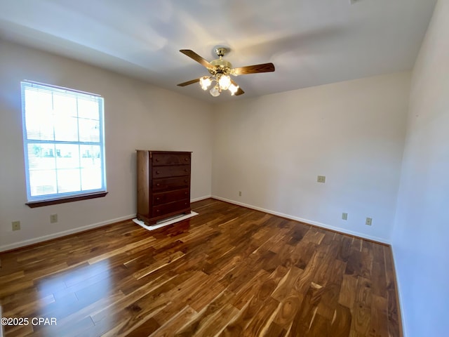 spare room featuring dark hardwood / wood-style floors and ceiling fan