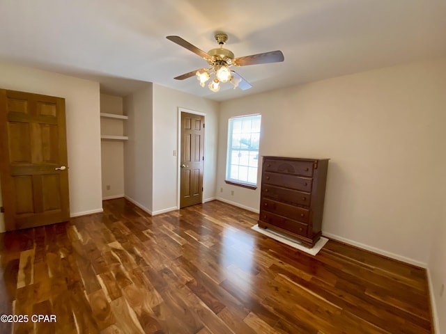 unfurnished bedroom with ceiling fan and dark hardwood / wood-style floors