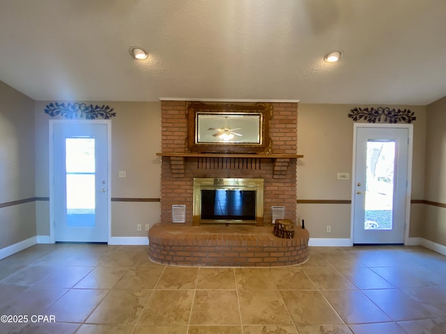 unfurnished living room with light tile patterned floors, a fireplace, and a textured ceiling