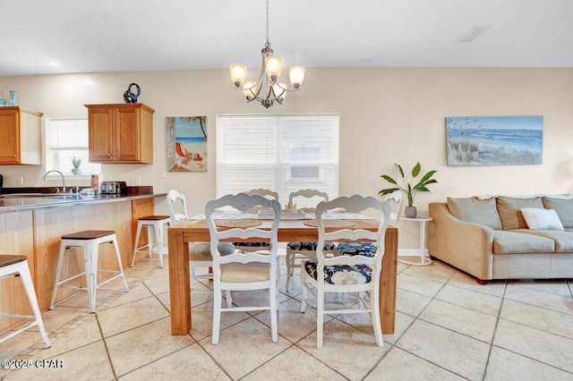 tiled dining area with an inviting chandelier