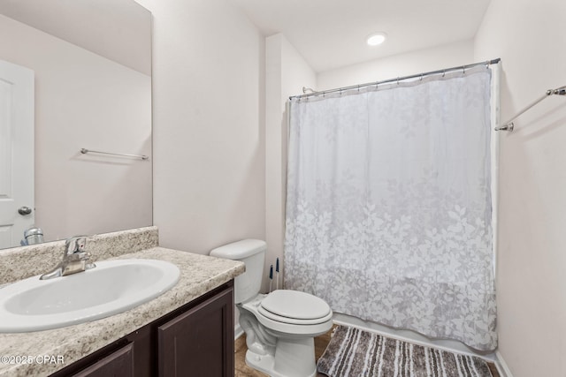 bathroom featuring toilet and vanity