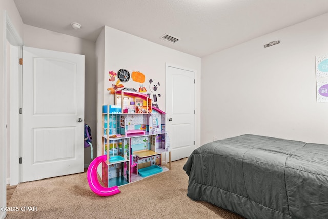 carpeted bedroom featuring visible vents