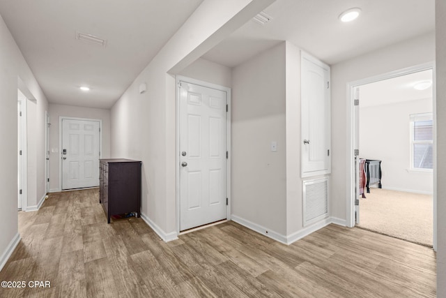 hall with visible vents, recessed lighting, baseboards, and light wood-style floors