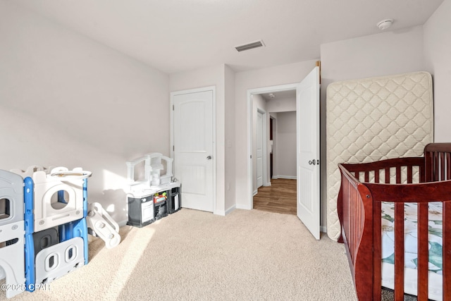 bedroom featuring visible vents, baseboards, and carpet floors