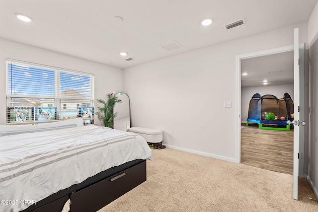 bedroom with visible vents, recessed lighting, baseboards, and carpet