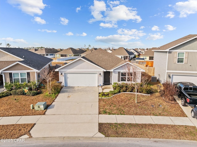 view of front facade with cooling unit, a residential view, an attached garage, and driveway