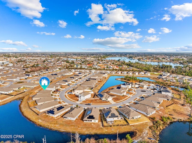 birds eye view of property with a residential view and a water view