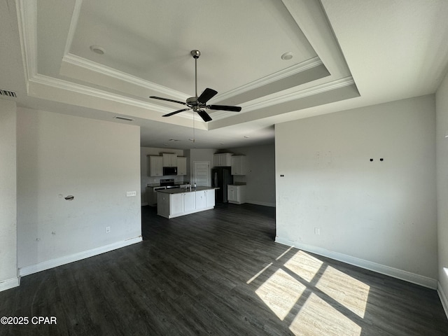 unfurnished living room featuring a raised ceiling, ornamental molding, dark hardwood / wood-style floors, and ceiling fan