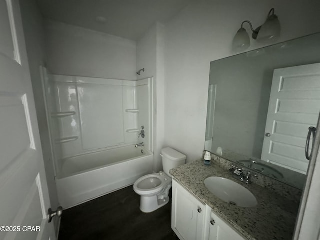 full bathroom featuring washtub / shower combination, vanity, and toilet