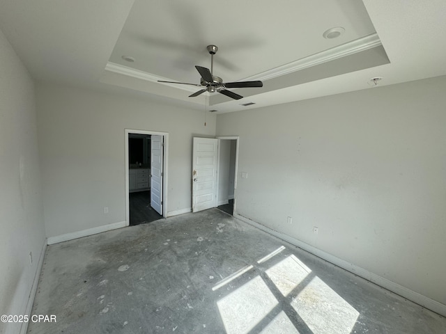 unfurnished bedroom featuring a tray ceiling and ceiling fan