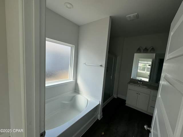 bathroom featuring plenty of natural light, shower with separate bathtub, and vanity