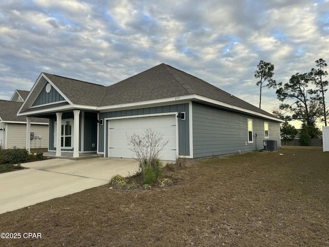 view of side of property featuring a garage, a porch, and cooling unit