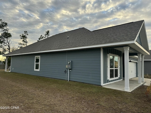 view of side of property with a yard