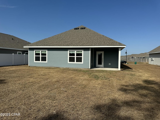 back of house with a lawn