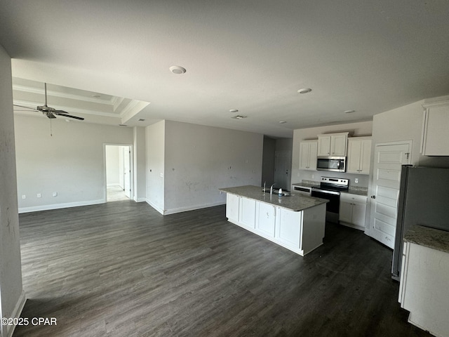 kitchen featuring appliances with stainless steel finishes, dark hardwood / wood-style floors, white cabinetry, sink, and a kitchen island with sink