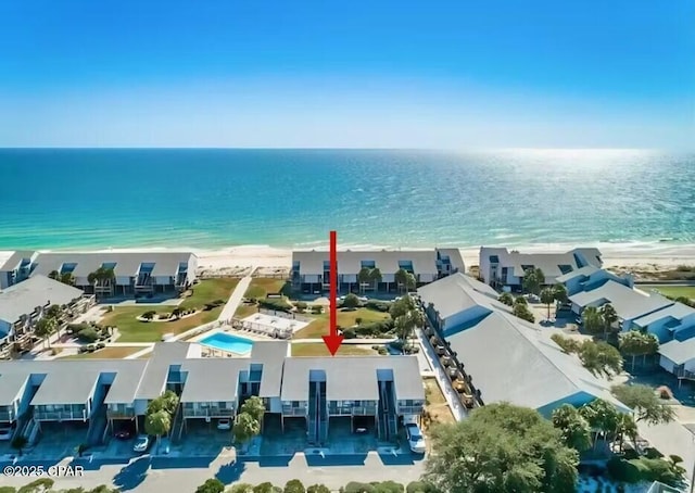 aerial view with a water view and a beach view